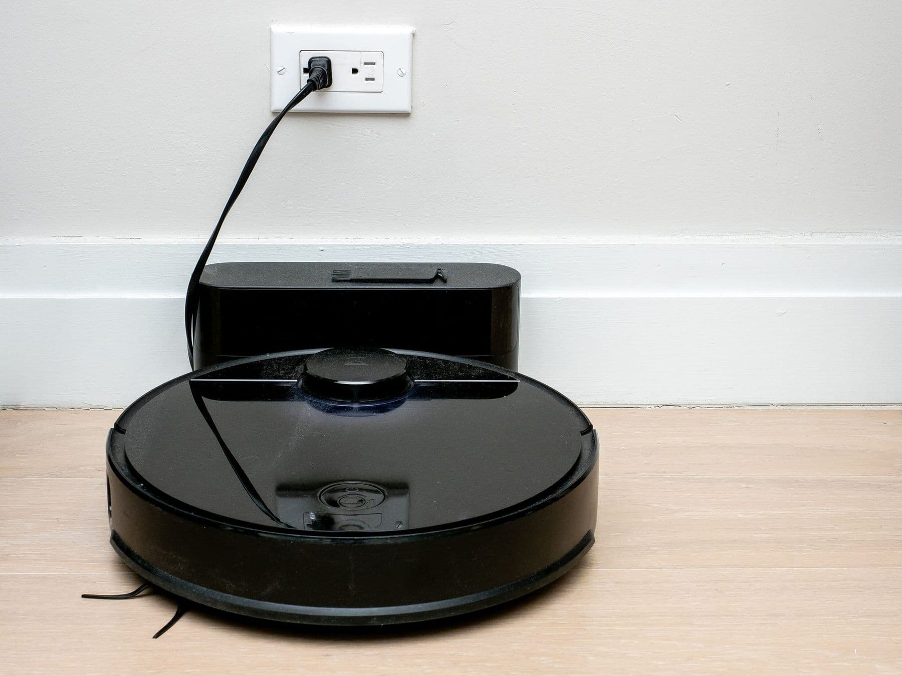 Robot vacuum cleaner at its charging dock, an everyday mechatronics example