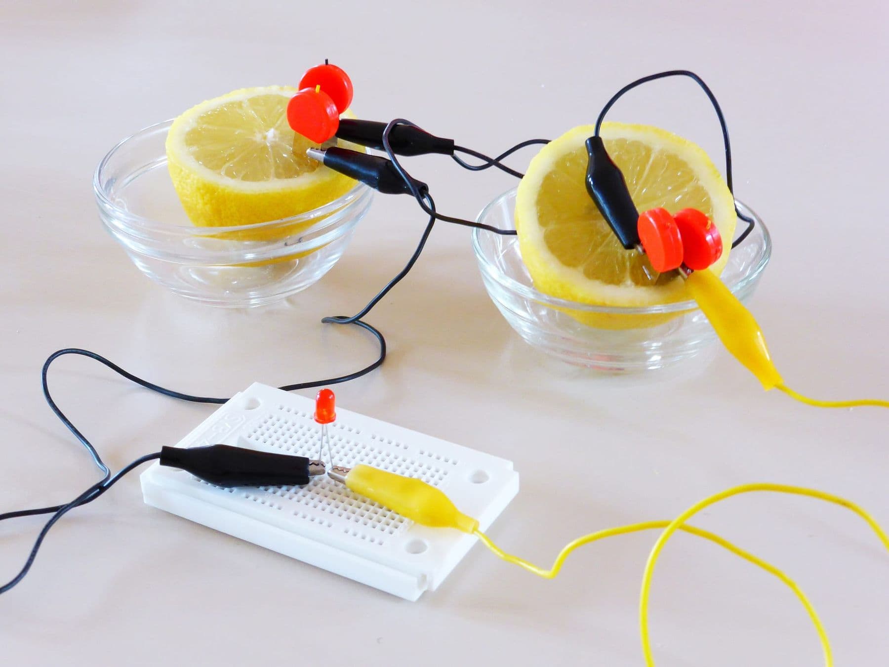 Lemon battery: two lemon halves wired to light an LED on a breadboard