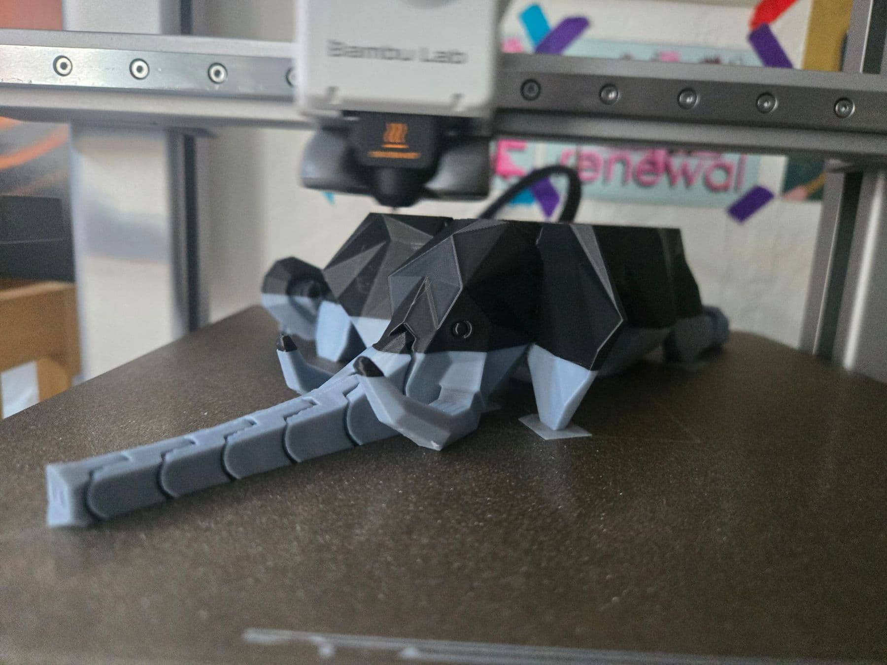 Two-colour elephant figure printed on a 3D printer, on the bed