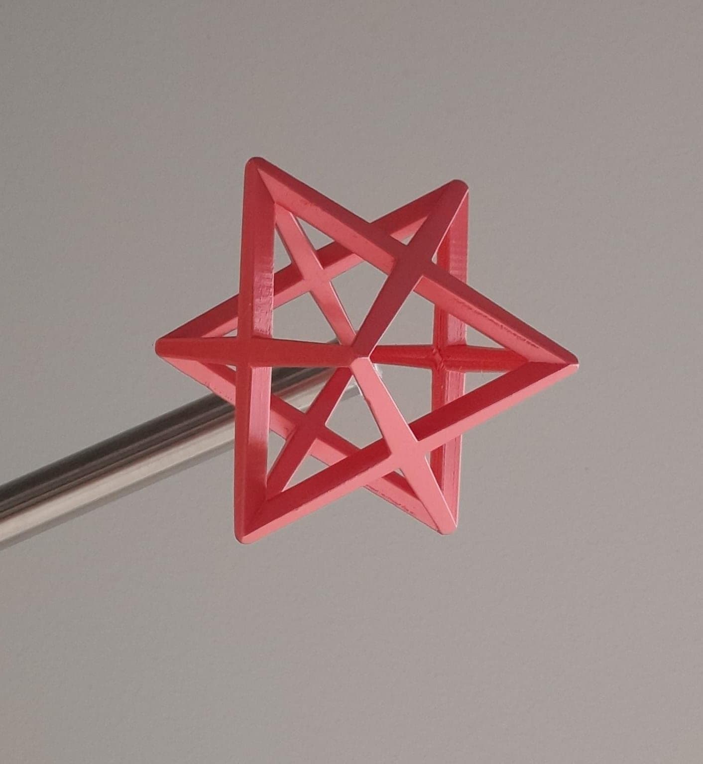 Pink 3D-printed star-shaped polyhedron, geometry with 3D printing
