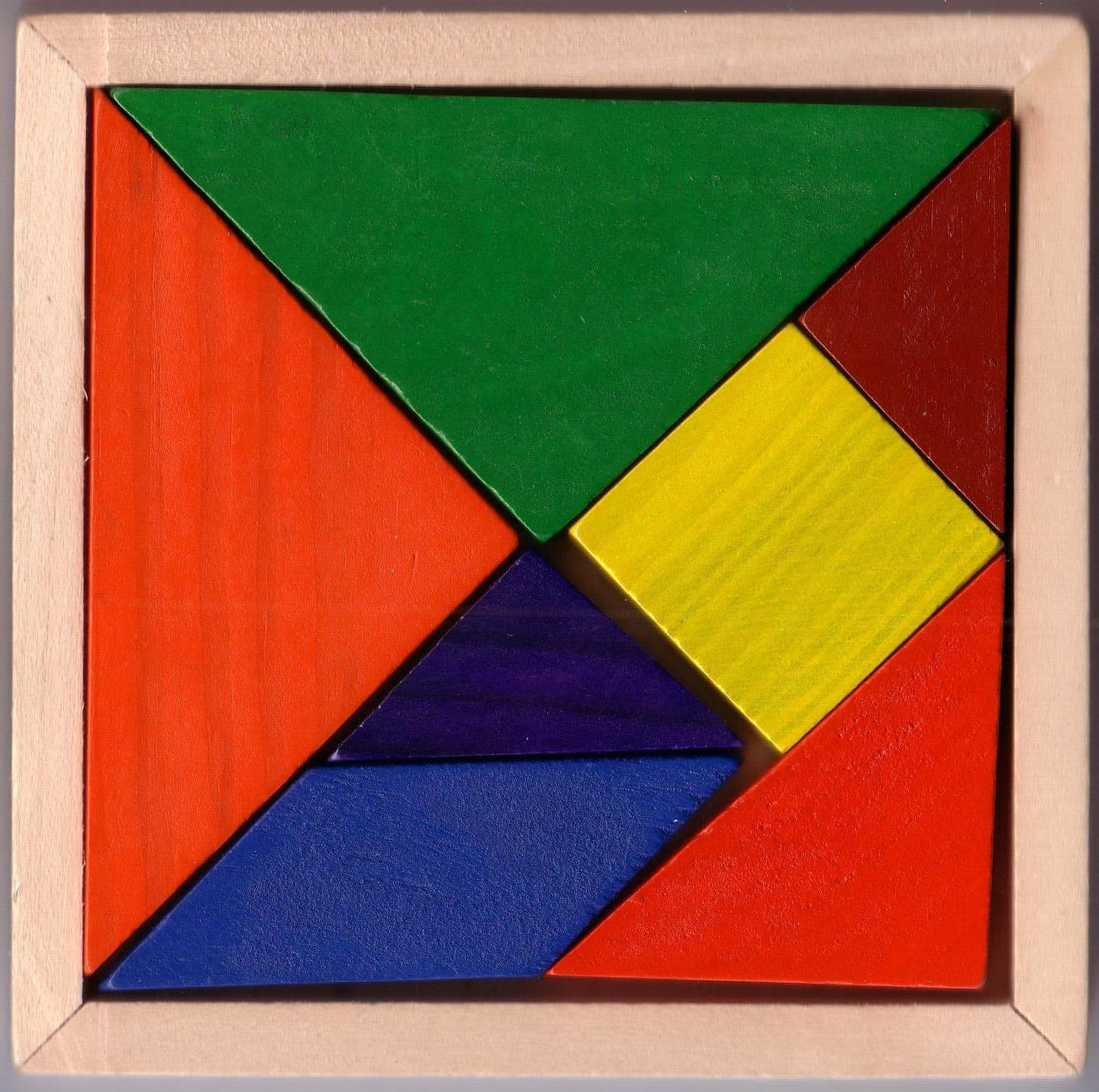 Colourful wooden tangram: seven pieces in a square, fractions and area