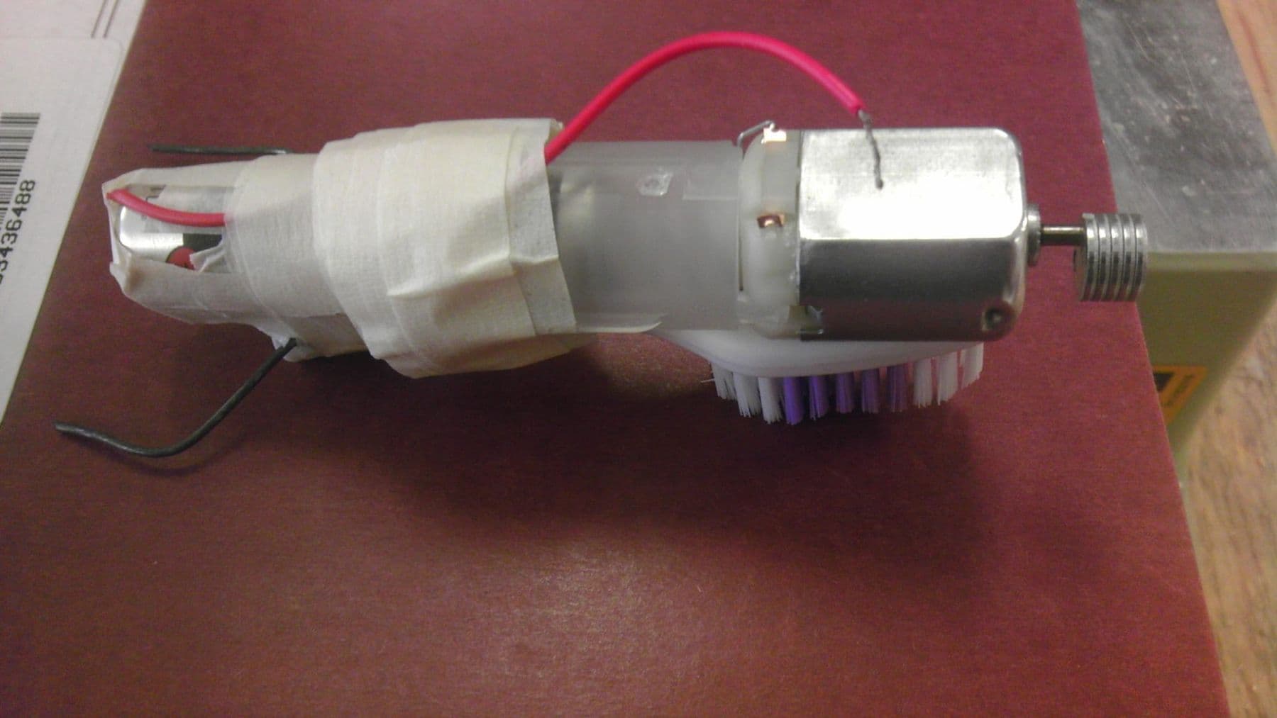 Homemade bristlebot made from a toothbrush head, a small motor and a battery